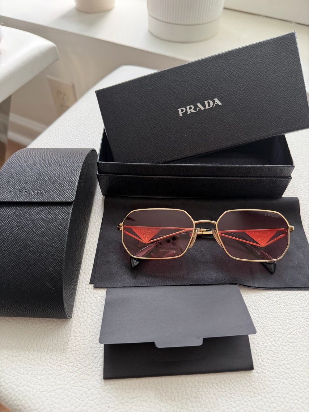 Prada Gold Frame Sunglasses with Pink Lenses